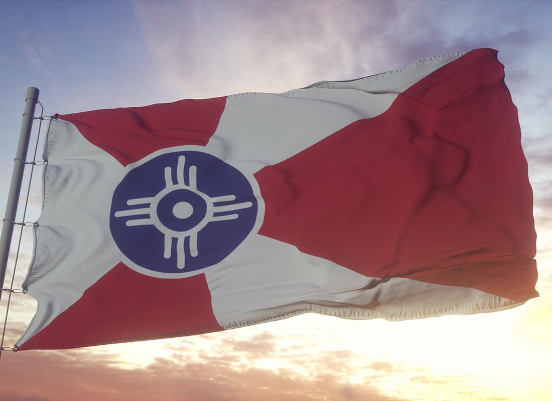 About Our Agency - Closeup View of the Wichita Kansas Flag Against a Colorful Sky